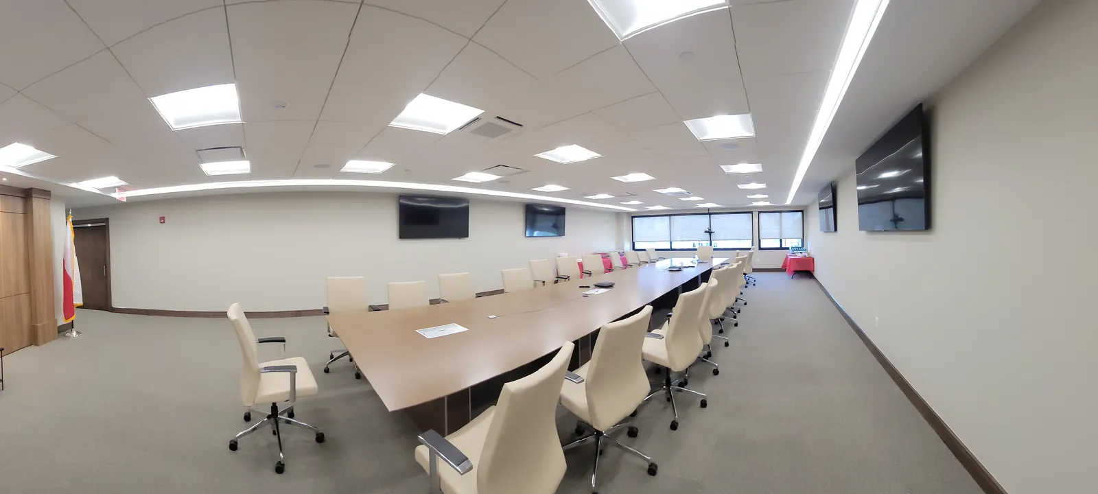 Corporate conference room with wall displays and video conferencing