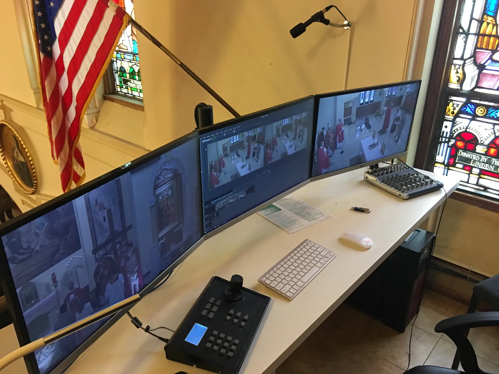 Live-streaming control room with multiple monitors and camera controller