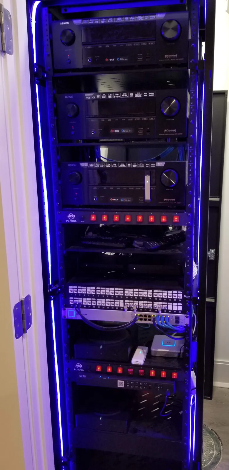 Equipment rack with AV receivers and blue LED lighting