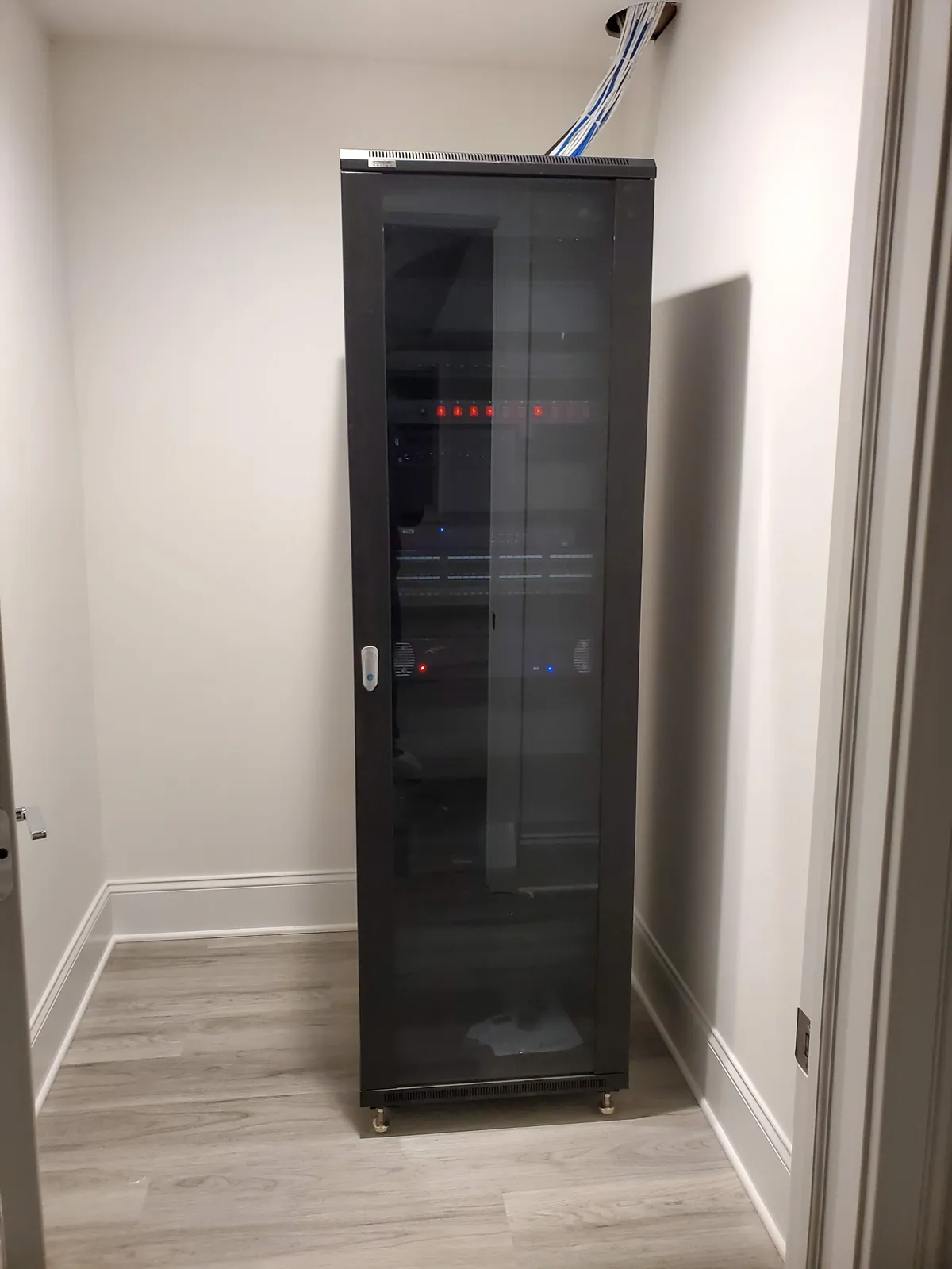 Enclosed equipment cabinet with network and AV gear