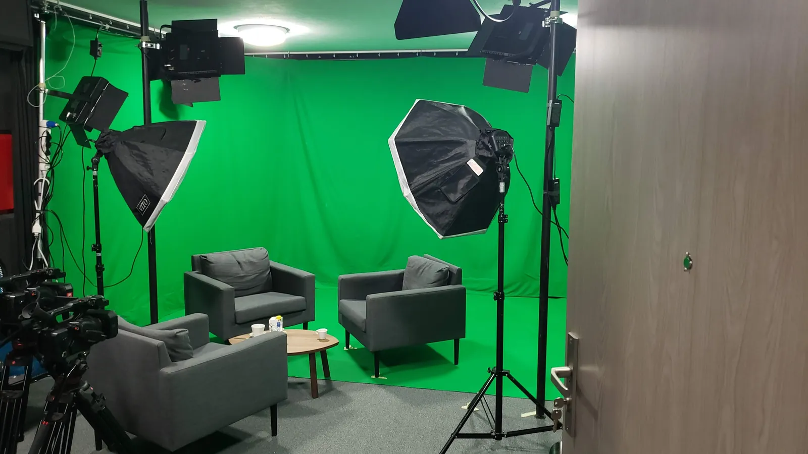 Green-screen video studio with lighting and cameras