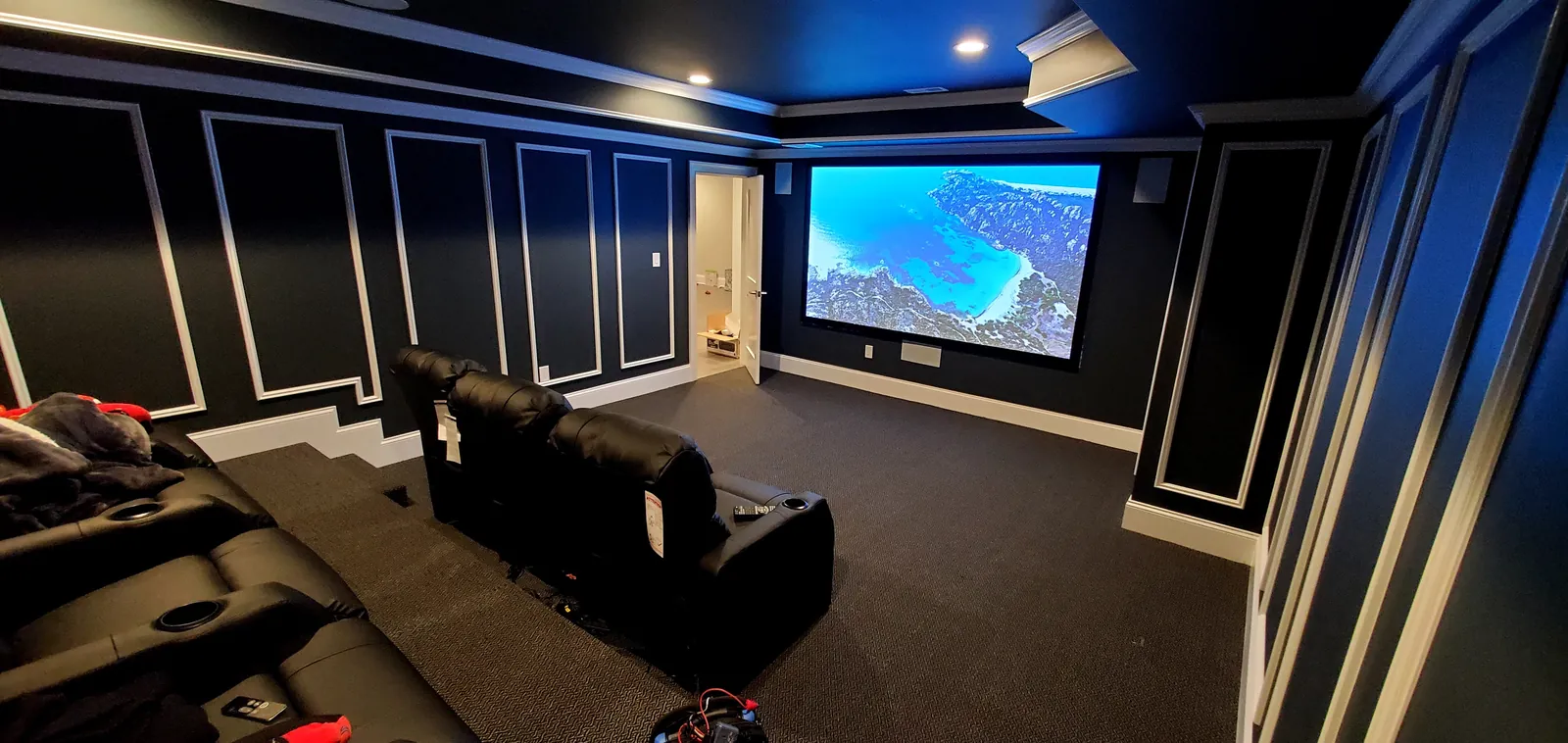 Dark home theater with image on the projection screen